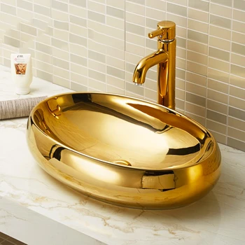 Umývadlo, zlatý stôl umývadlo, nové oválne keramické pozlátené umývadlo, domov hotel kúpeľňa